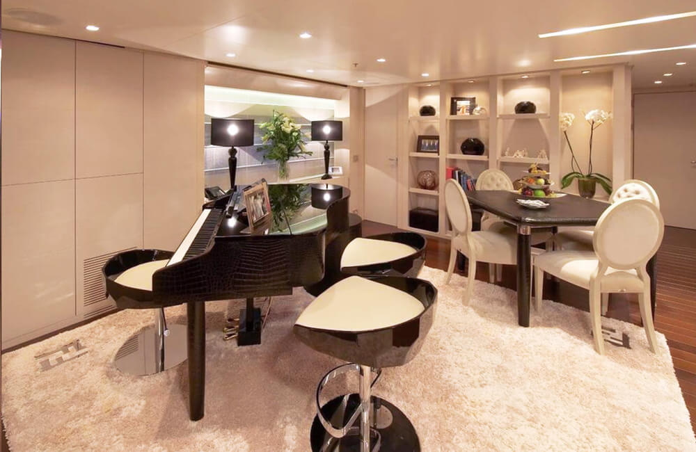 Piano and sitting area on white shag carpet