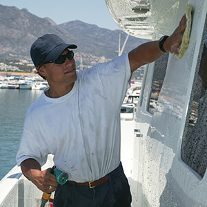 Bosun polishing the yacht