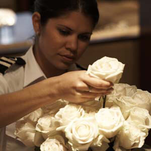 Yacht 2nd Stewardess arranging white roses