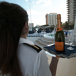 Yacht Butler serving champagne