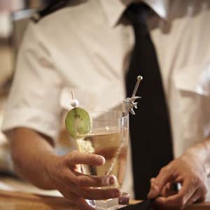 Yacht Steward serving a cocktail