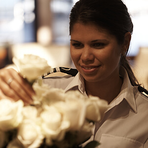 Yachts Chief Steward or Head of Housekeeping arranging white roses